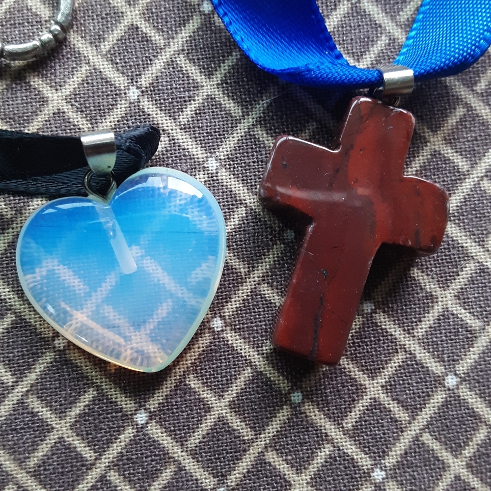 2 pendants, one a jasper cross & one, opalite glass heart on satin cords